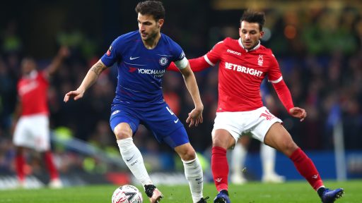 Cesc Fabregas Chelsea is challenged by Matty Cash Nottingham Forest