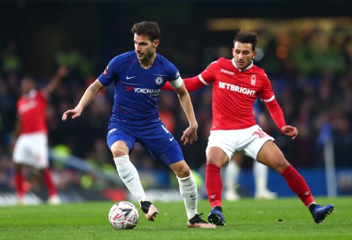 Cesc Fabregas Chelsea is challenged by Matty Cash Nottingham Forest