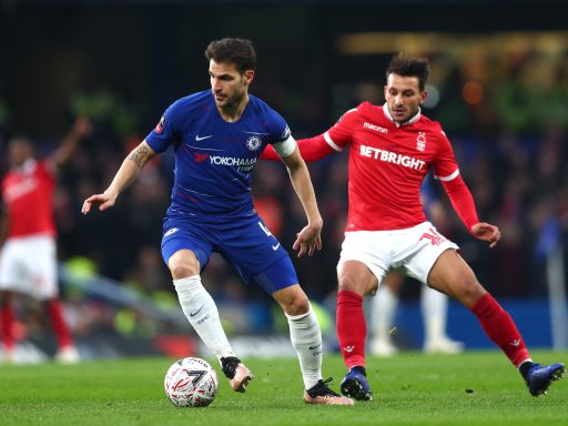 Cesc Fabregas Chelsea is challenged by Matty Cash Nottingham Forest