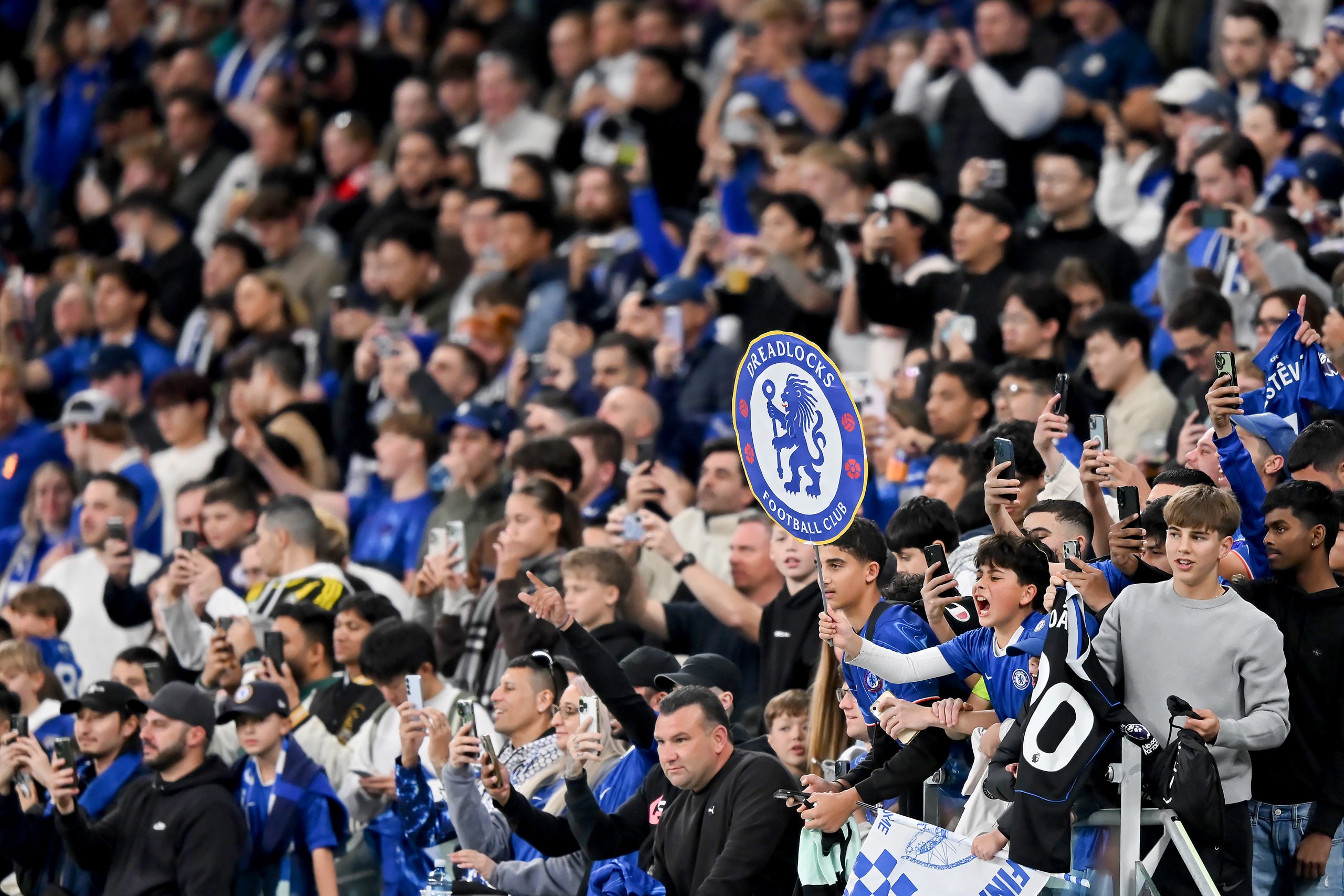 Fans cheer as the players walk out to train during a Chelsea FC Open Training Session at Allianz Stadium