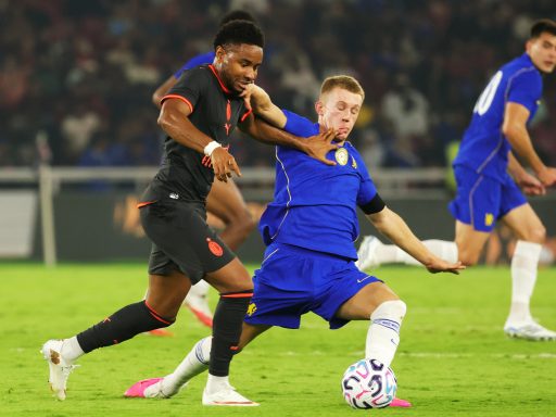 Christopher Nkunku of AC Milan competes for the ball against Reggie Watson of Chelsea