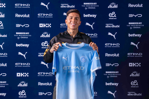 Enzo Fernandez signs for Manchester city and holds up the shirt