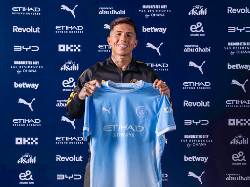 Enzo Fernandez signs for Manchester city and holds up the shirt