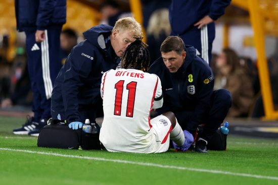 Jamie Gittens of England U21 is treated for an injury before being substituted during the UEFA U21 EURO 2027 Qualifier between England and Kazakhstan